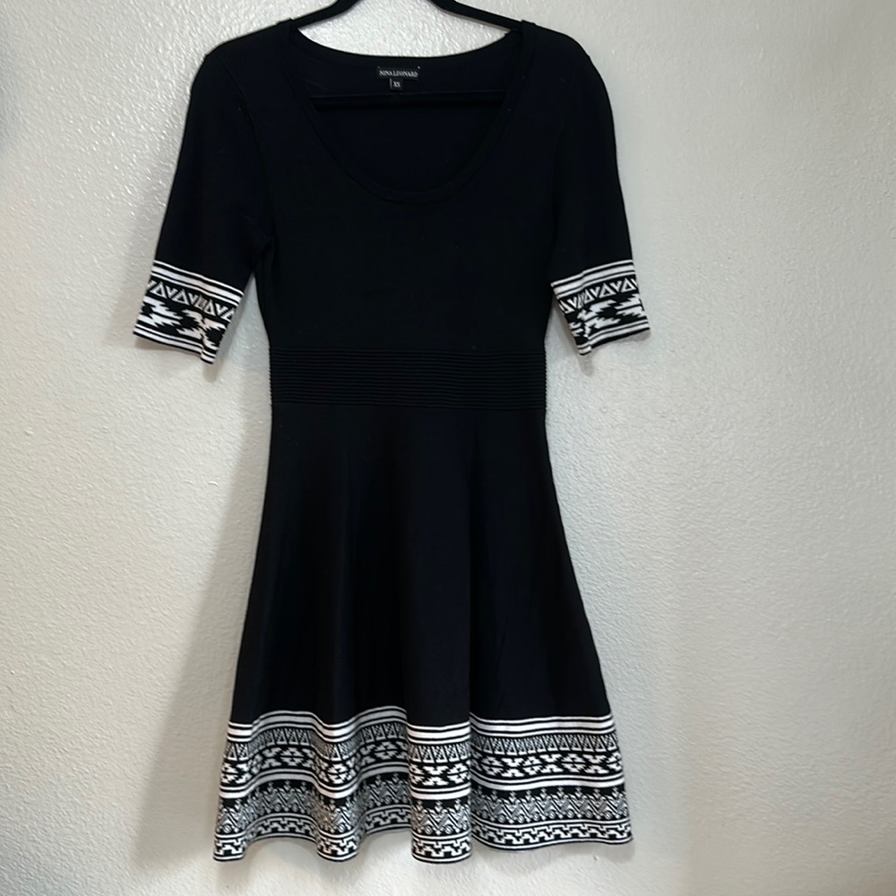 Black knit midi short sleeve dress with an oval neck black and white pattern